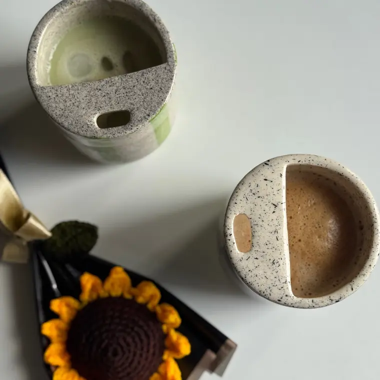 Matcha and coffee in speckled ceramic cups, shot from above